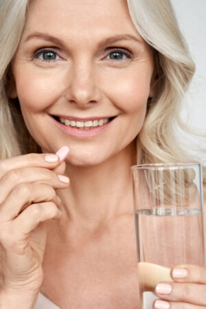 Smiling,Happy,Healthy,Middle,Aged,50s,Woman,Holding,Glass,Of